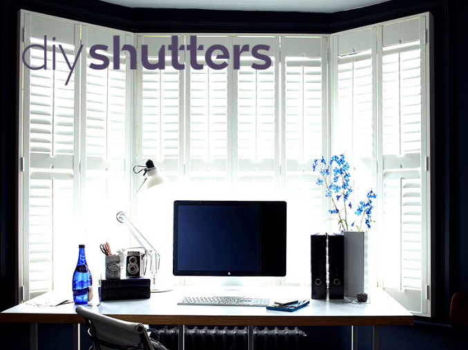 White bay window shutters in home office