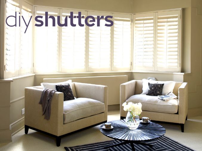 4.png White bay window shutters with cream armchairs