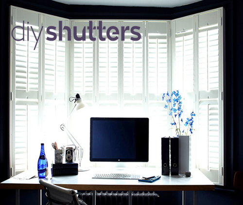 White bay window shutter blinds in home office