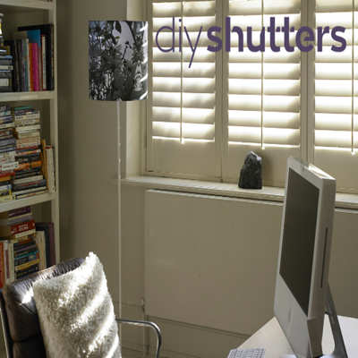Cream window shutters in home office