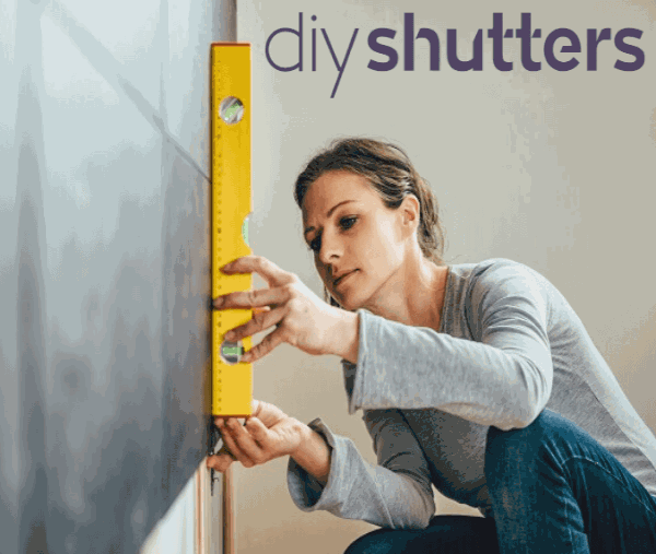 Woman measuring for DIY shutters